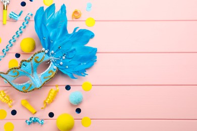 Photo of Flat lay composition with carnival items on pink wooden background. Space for text