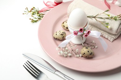 Photo of Festive Easter table setting with beautiful floral decor, closeup