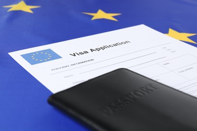 Immigration to Europe. Visa application form and passport on flag, closeup