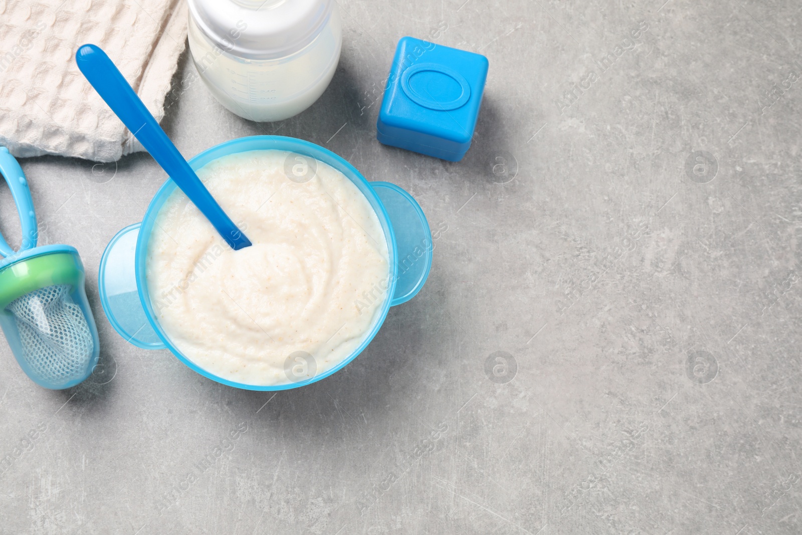 Photo of Flat lay composition with healthy baby food on grey table, space for text