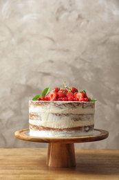 Delicious homemade cake with fresh berries on wooden table