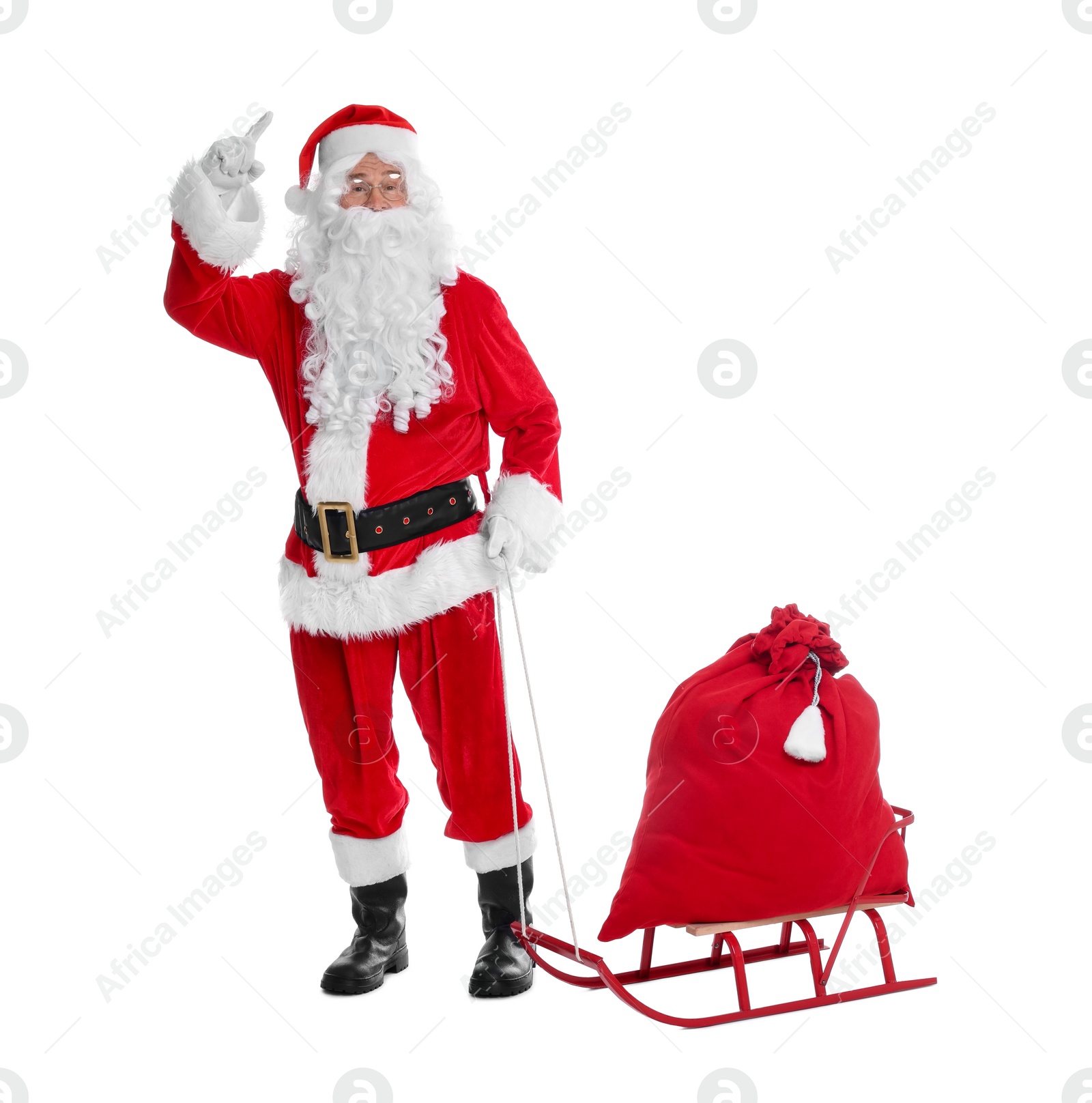 Photo of Man in Santa Claus costume with bag and sleigh on white background