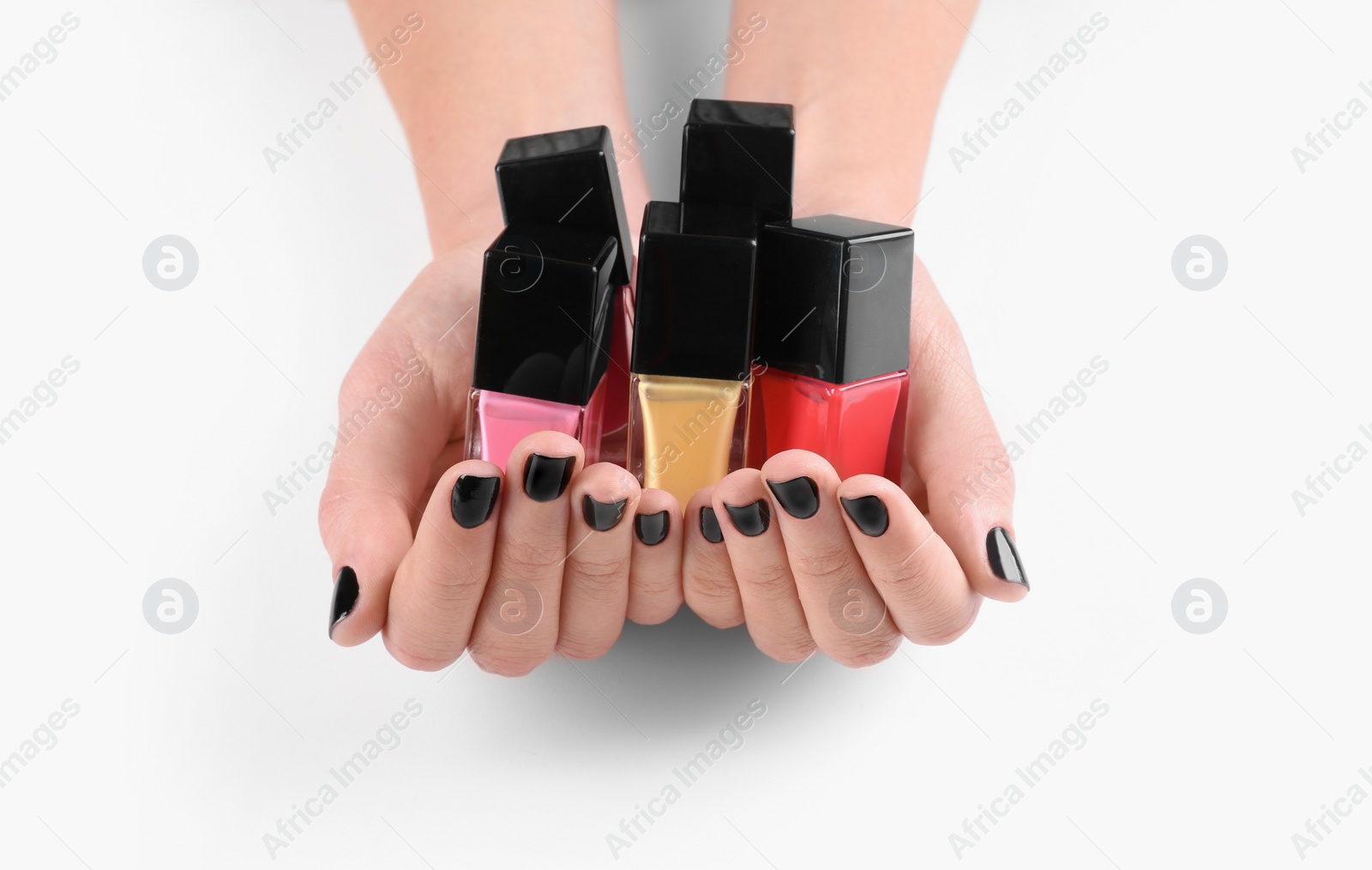 Photo of Woman holding nail polish bottles isolated on white, closeup