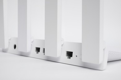 One modern Wi-Fi router on white background, closeup