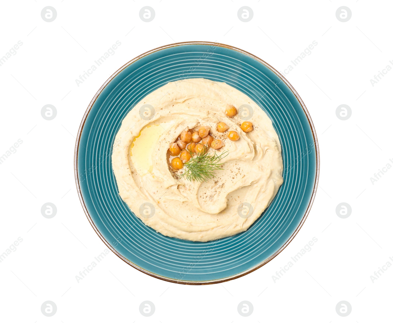 Photo of Plate of tasty hummus with garnish isolated on white, top view