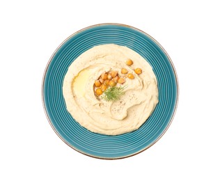 Photo of Plate of tasty hummus with garnish isolated on white, top view