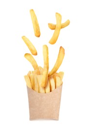 Tasty French fries falling into paper takeaway container on white background