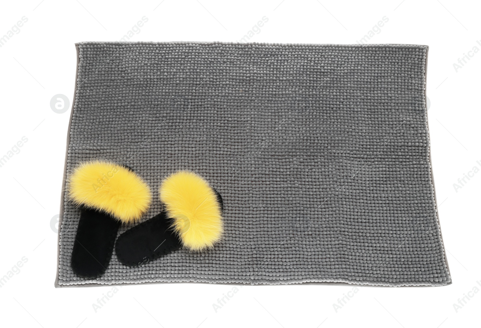 Photo of Soft grey bath mat and slippers isolated on white, top view