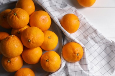Photo of Many fresh ripe tangerines on white wooden table, flat lay