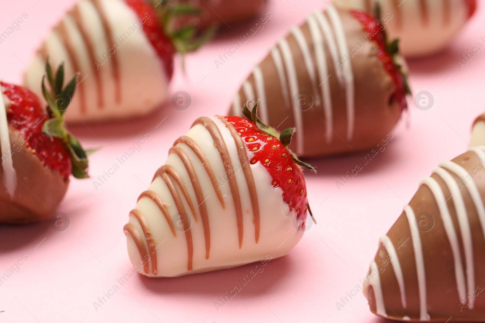 Photo of Delicious chocolate covered strawberries on pink background, closeup