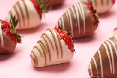 Photo of Delicious chocolate covered strawberries on pink background, closeup