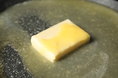 Photo of Melting butter in frying pan, closeup view