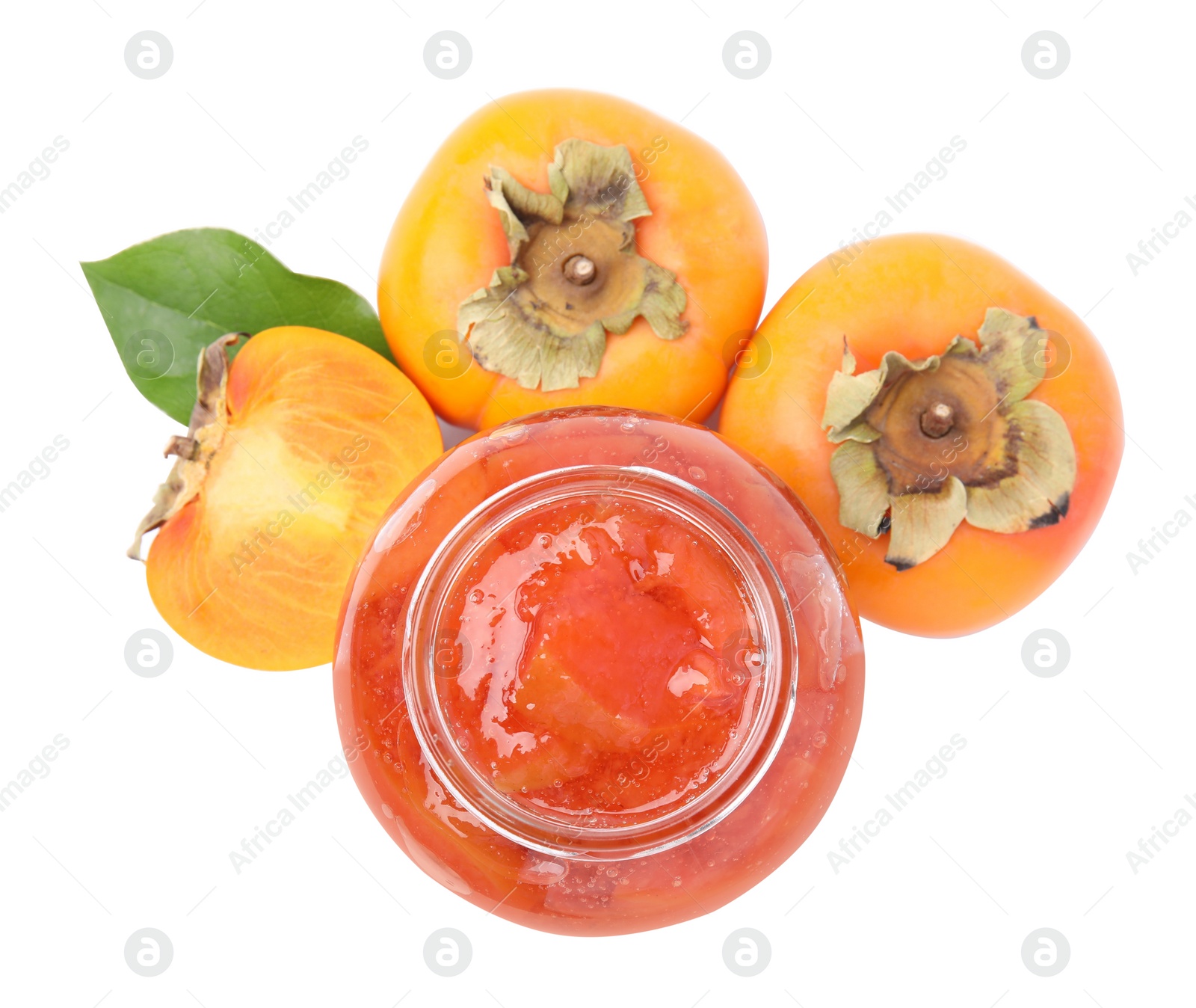 Photo of Jar of tasty persimmon jam with fresh fruits on white background, top view