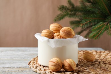 Photo of Delicious nut shaped cookies on blue rustic table