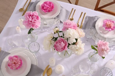 Stylish table setting with beautiful peonies in dining room