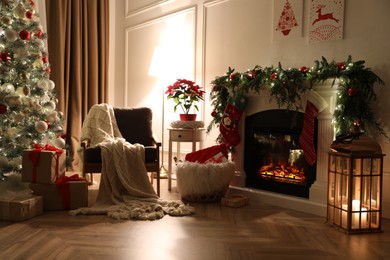Photo of Stylish room interior with fireplace and beautiful Christmas tree
