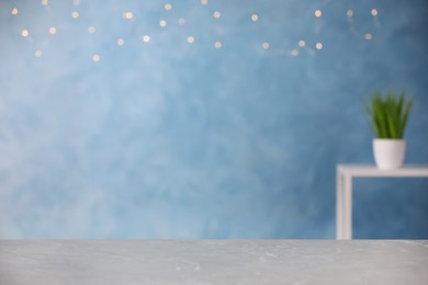 Photo of Empty grey marble table on light blue background