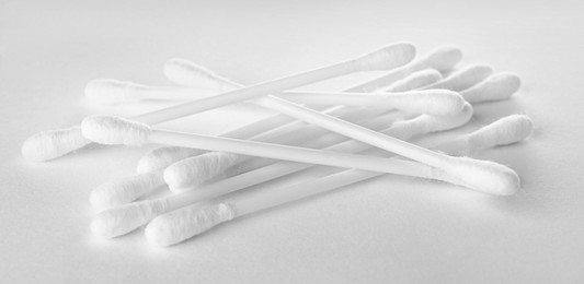 Photo of Heap of clean cotton buds on white background