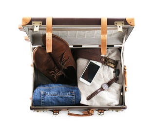 Photo of Packed suitcase with warm clothes and smartphone on white background, top view. Space for text