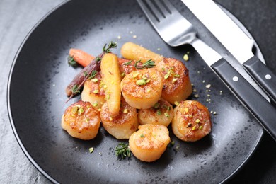 Photo of Delicious fried scallops served on dark gray table, closeup