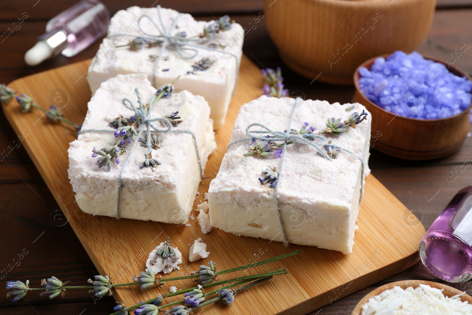 Photo of Hand made soap bars with lavender flowers on wooden board