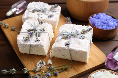 Hand made soap bars with lavender flowers on wooden board