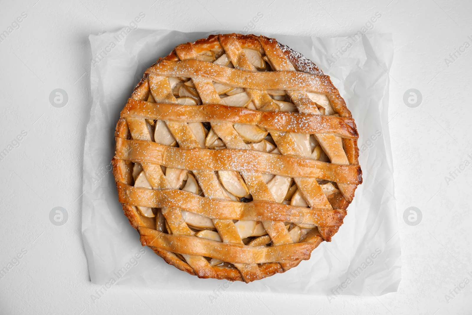 Photo of Delicious traditional apple pie on white table, top view