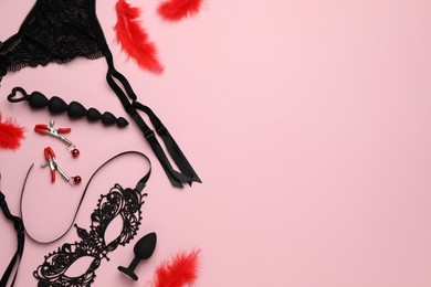 Photo of Sex toys and accessories on pink background, flat lay. Space for text