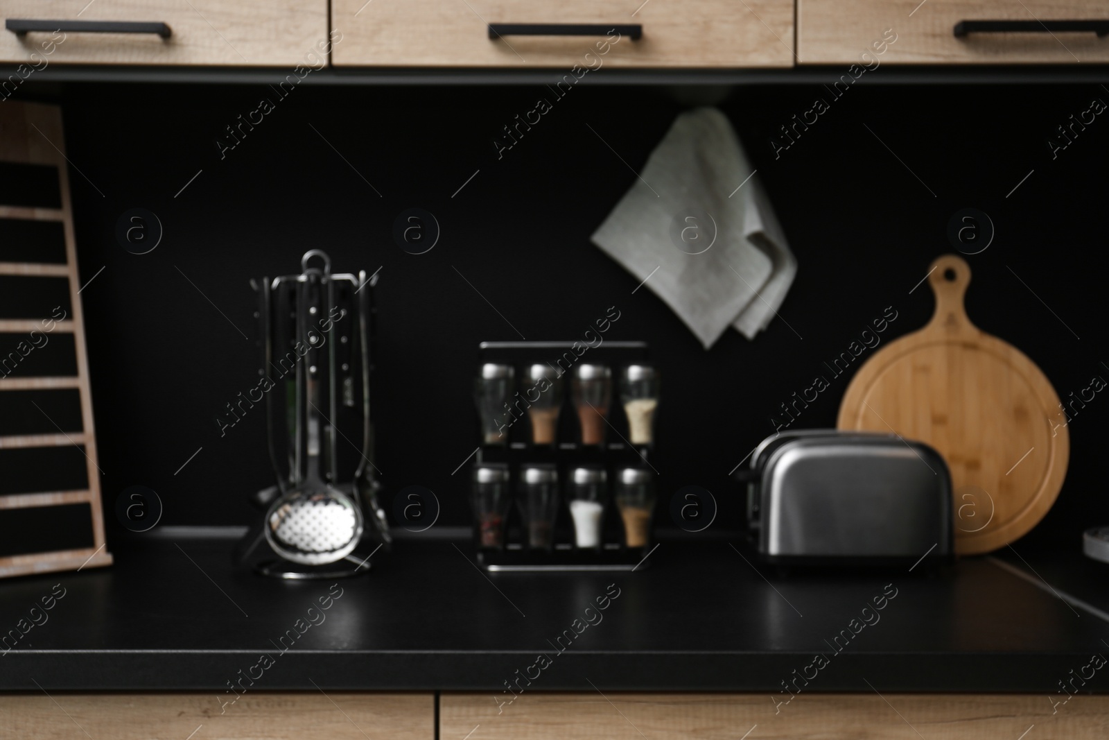 Photo of Blurred view of kitchen interior with modern furniture