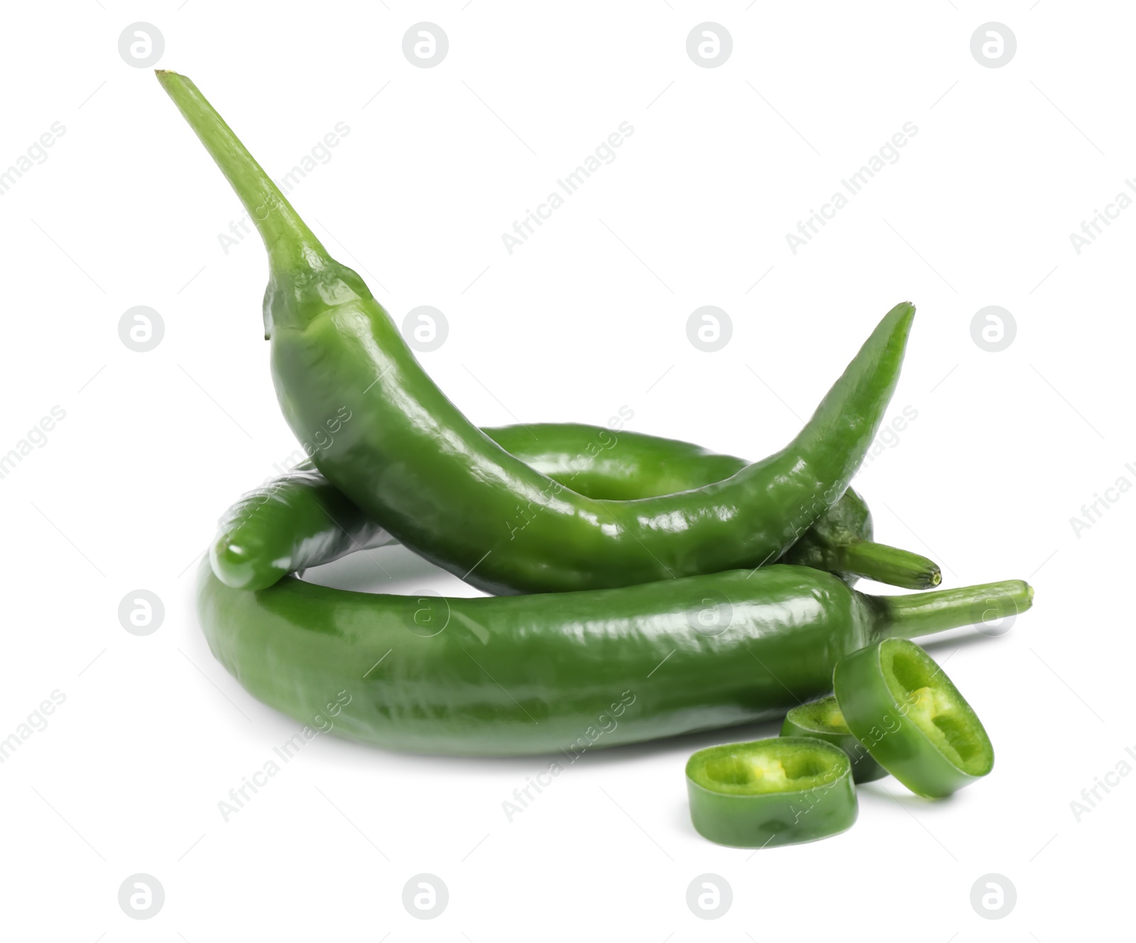 Photo of Cut and whole green hot chili peppers on white background