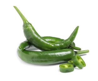 Photo of Cut and whole green hot chili peppers on white background