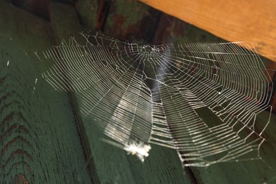 Photo of Cobweb on wooden building outdoors, low angle view