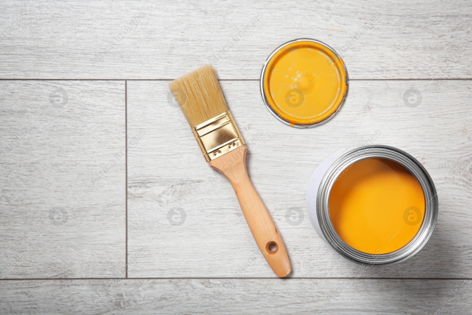 Photo of Flat lay composition with can of paint and brush on wooden background. Space for text