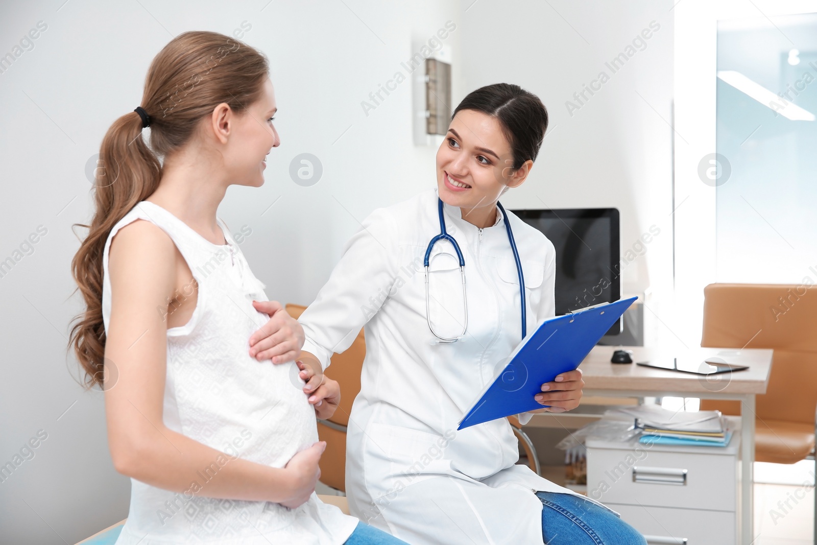 Photo of Pregnant woman having appointment at gynecologist office