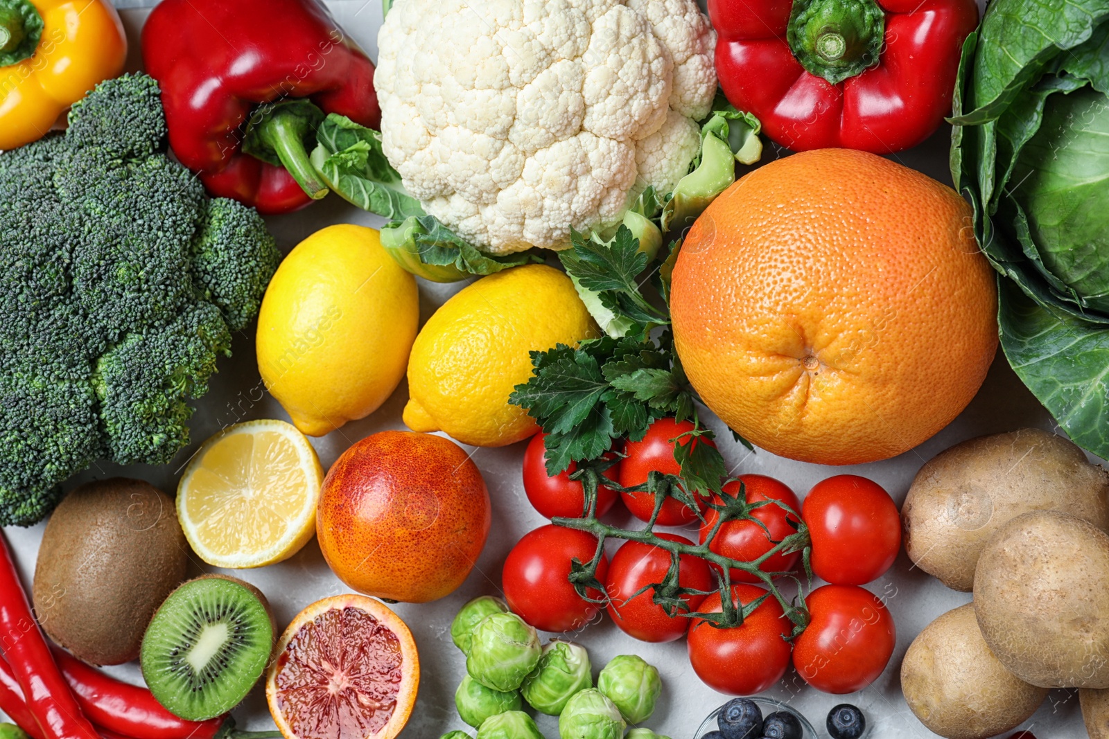 Photo of Different products rich in vitamin C on table, flat lay