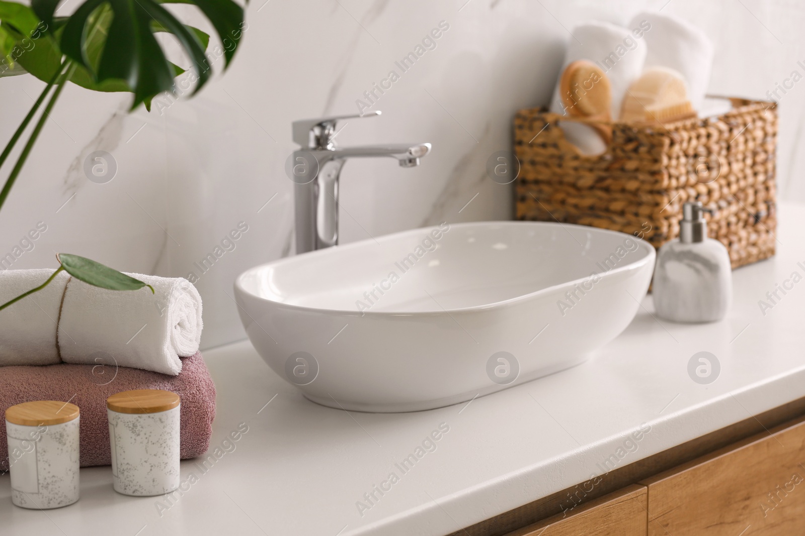 Photo of Stylish vessel sink on light countertop in modern bathroom