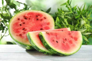 Photo of Fresh juicy watermelon with seeds on wooden table