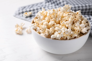 Bowl of delicious popcorn on light table