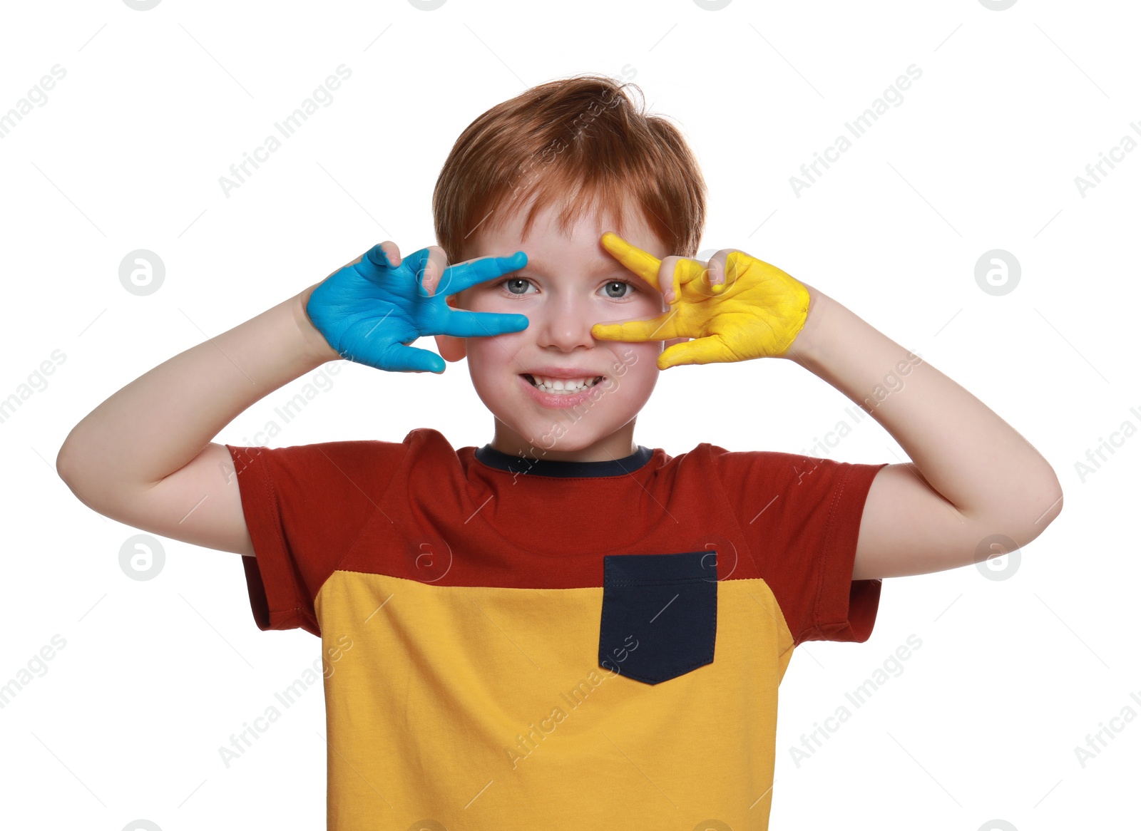 Photo of Little boy with hands painted in Ukrainian flag colors on white background. Love Ukraine concept