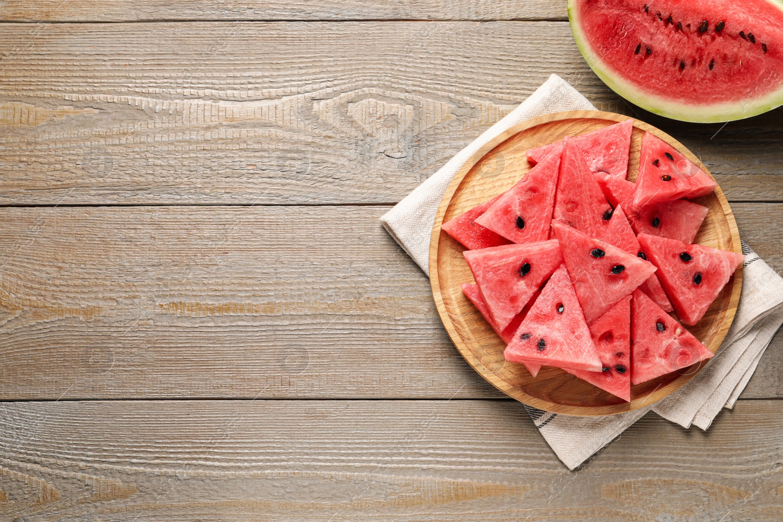 Photo of Delicious fresh watermelon slices on wooden table, flat lay. Space for text