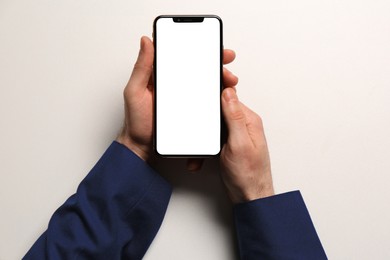 Photo of Man with smartphone on white background, top view