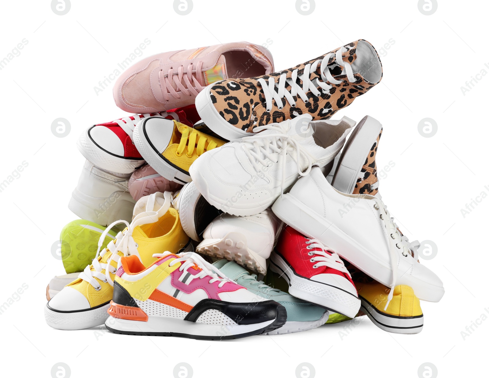 Photo of Pile of different female sneakers isolated on white