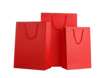 Photo of Red paper shopping bags isolated on white