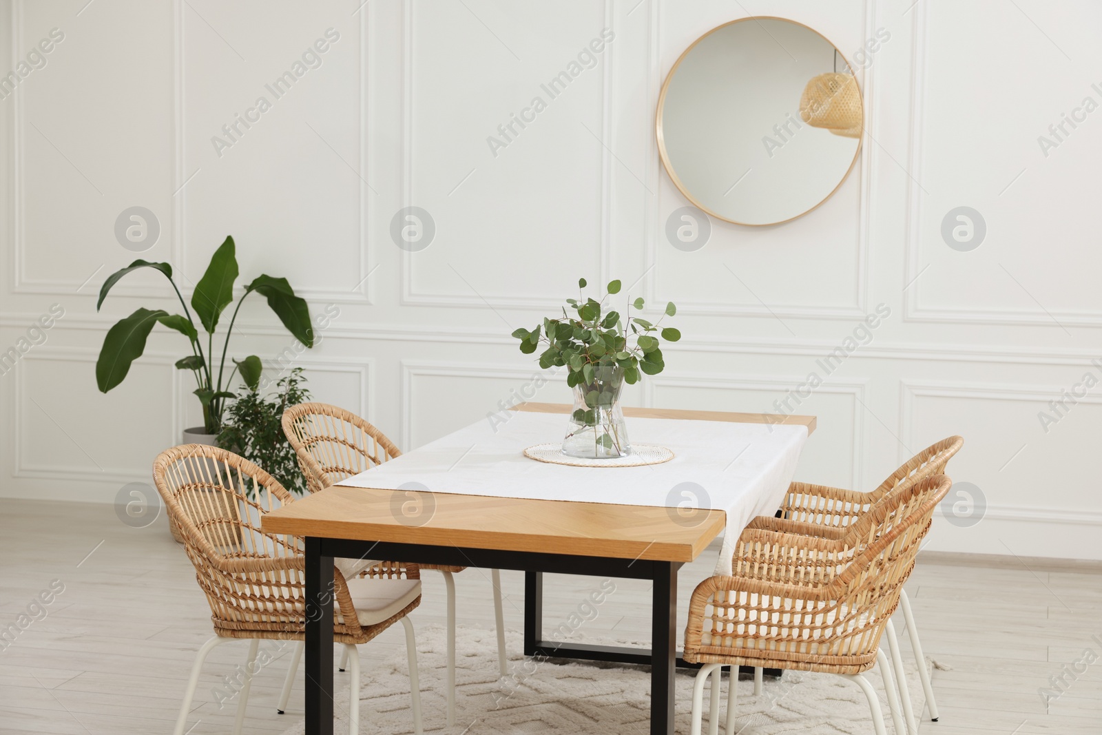 Photo of Stylish dining room with cozy furniture, mirror and plants