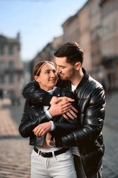 Lovely young couple together on city street. Romantic date