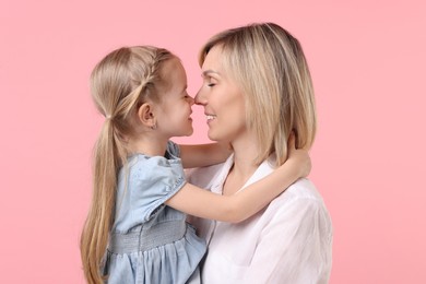 Photo of Family portrait of happy mother and daughter on pink background