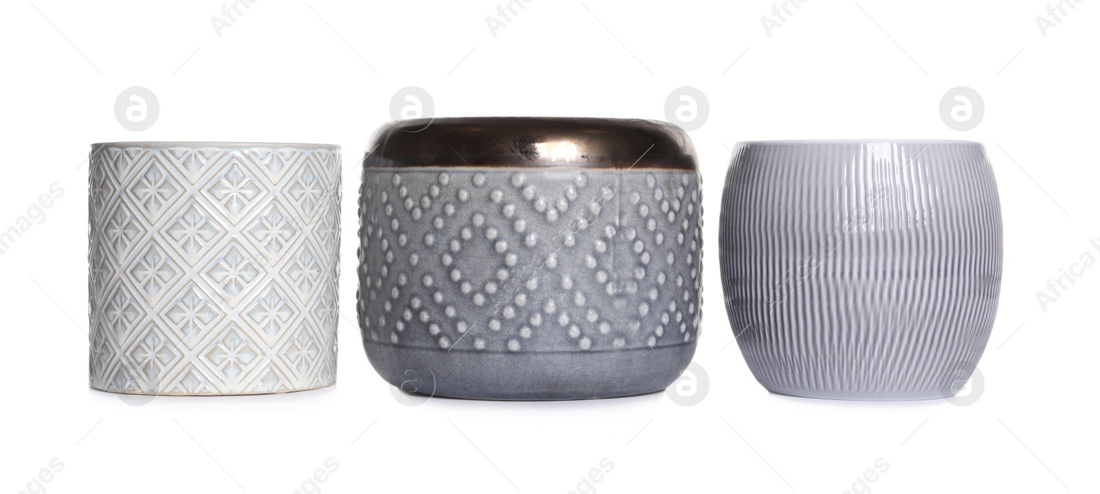 Photo of Different stylish ceramic flowerpots on white background