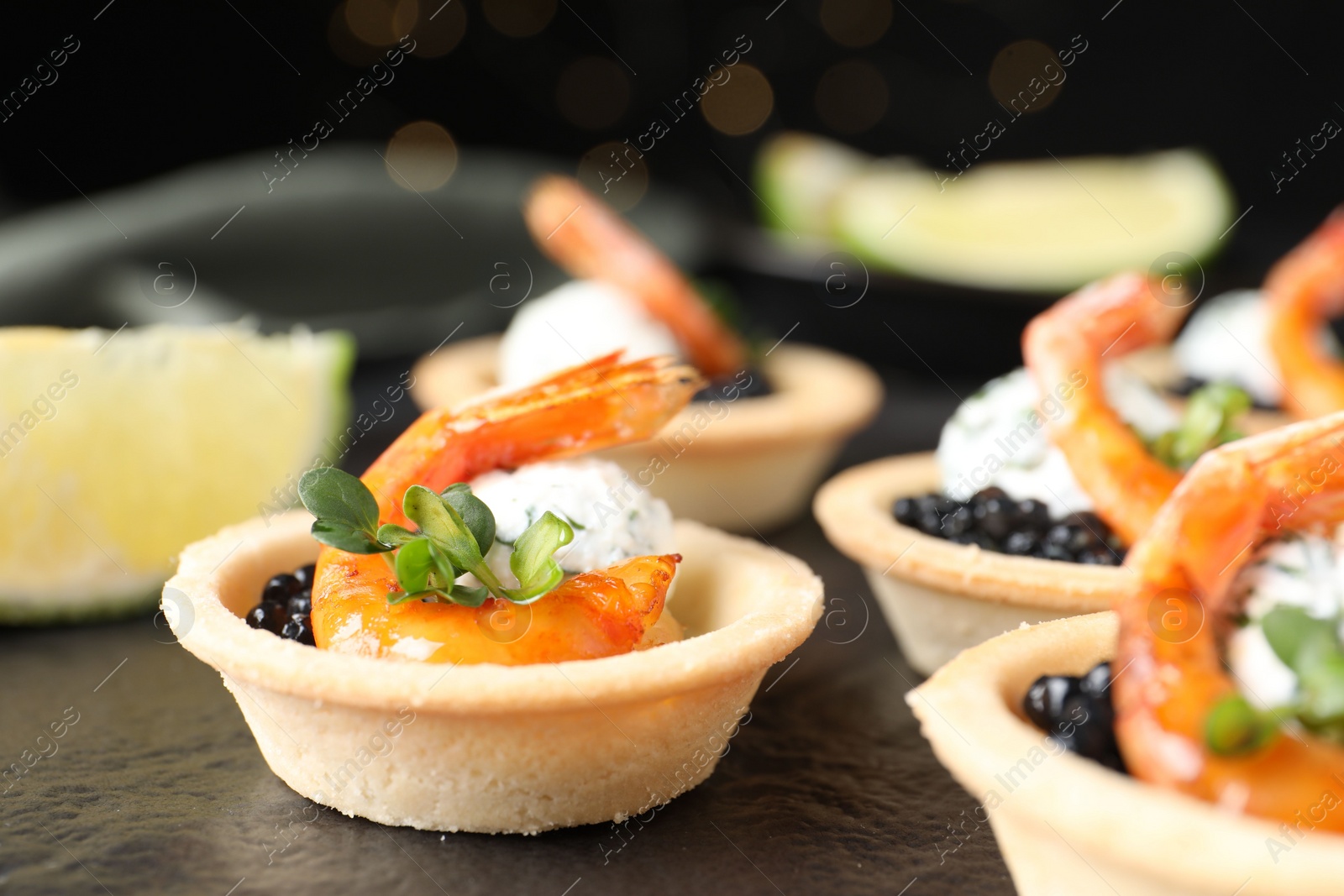 Photo of Delicious canapes with shrimps and black caviar on table, closeup