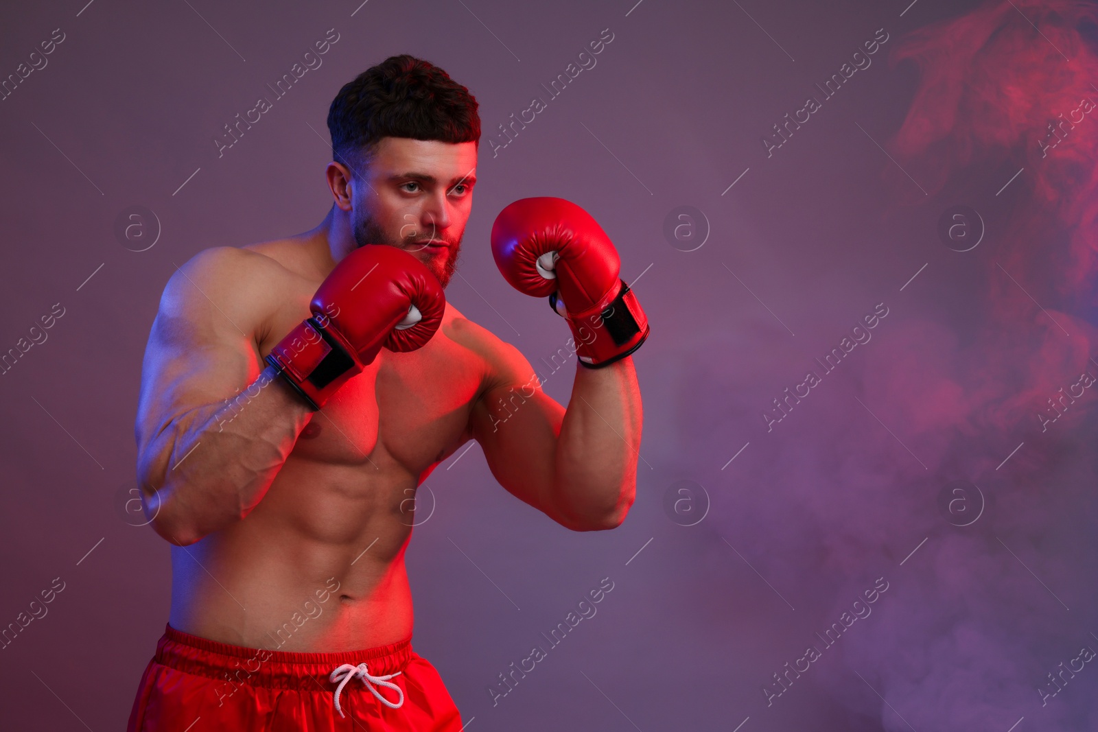 Photo of Man in boxing gloves on color background. Space for text