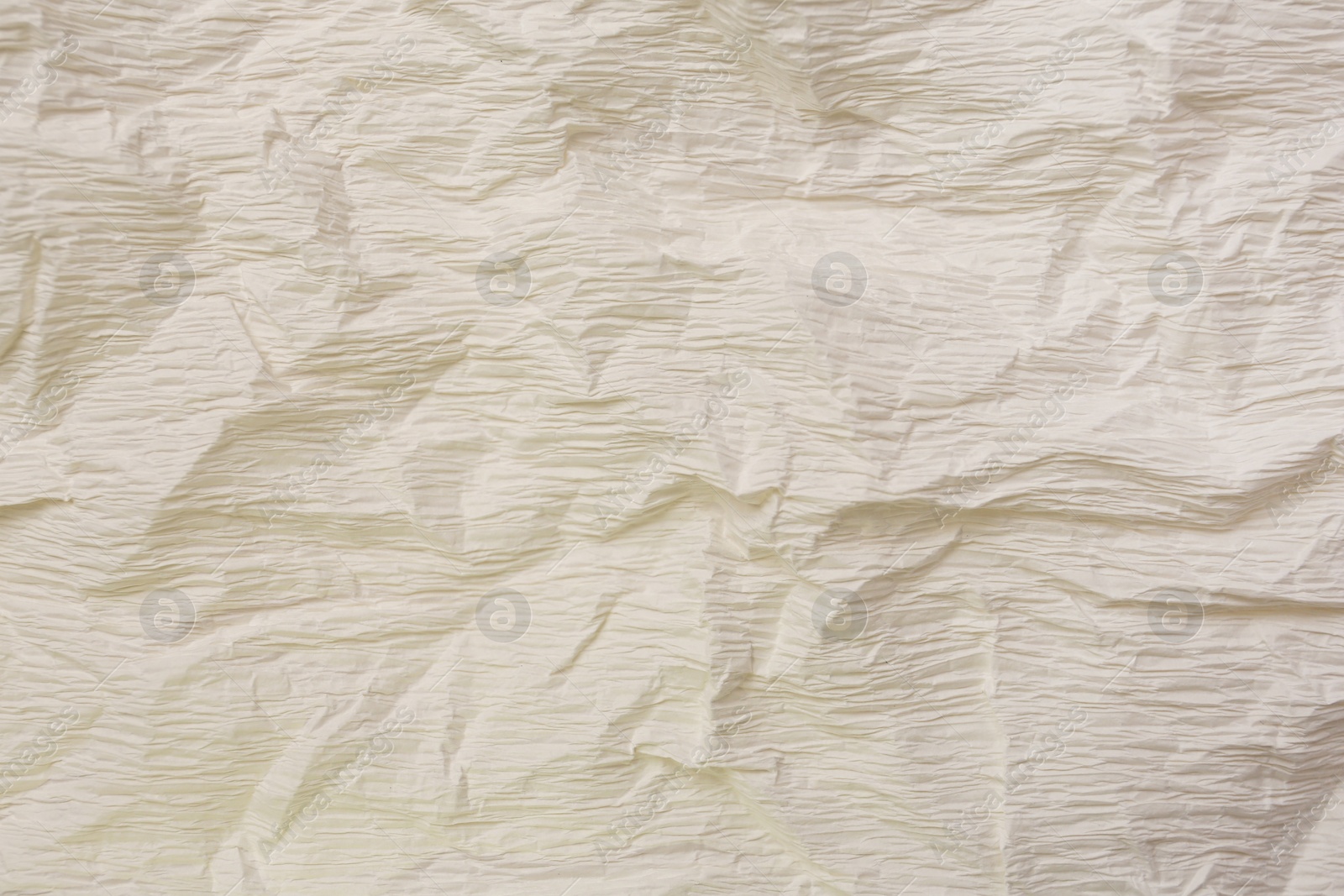 Photo of Texture of crumpled beige paper as background, closeup view